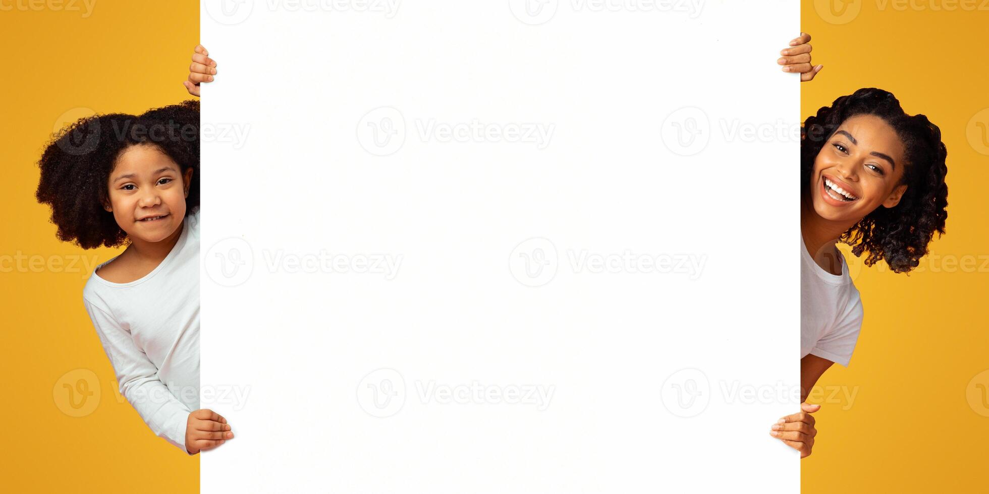 Place For Your Advertisement. Joyful African American Mom And Daughter Peeking Out Of Blank White Board Over Pink Background, Panorama photo
