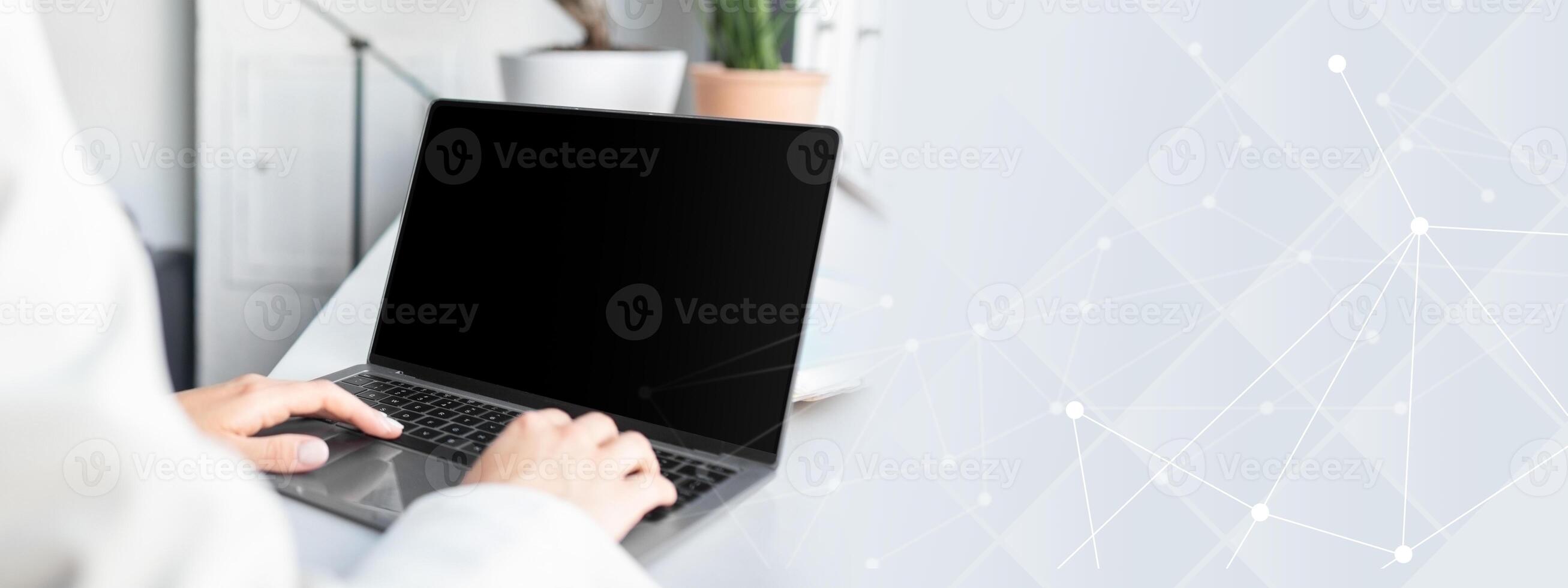 Unrecognizable businesswoman using laptop computer with white blank screen, typing on keyboard, mockup for ad, website design, copy space photo
