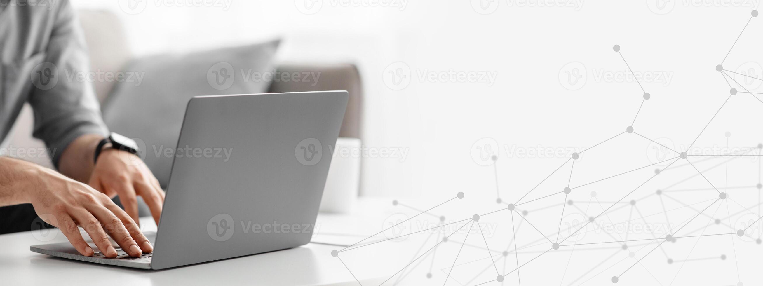 Working at laptop pc. Man hands on pc keyboard, typing text or programming code in computer, sitting on sofa at home, cropped, panorama with empty space photo