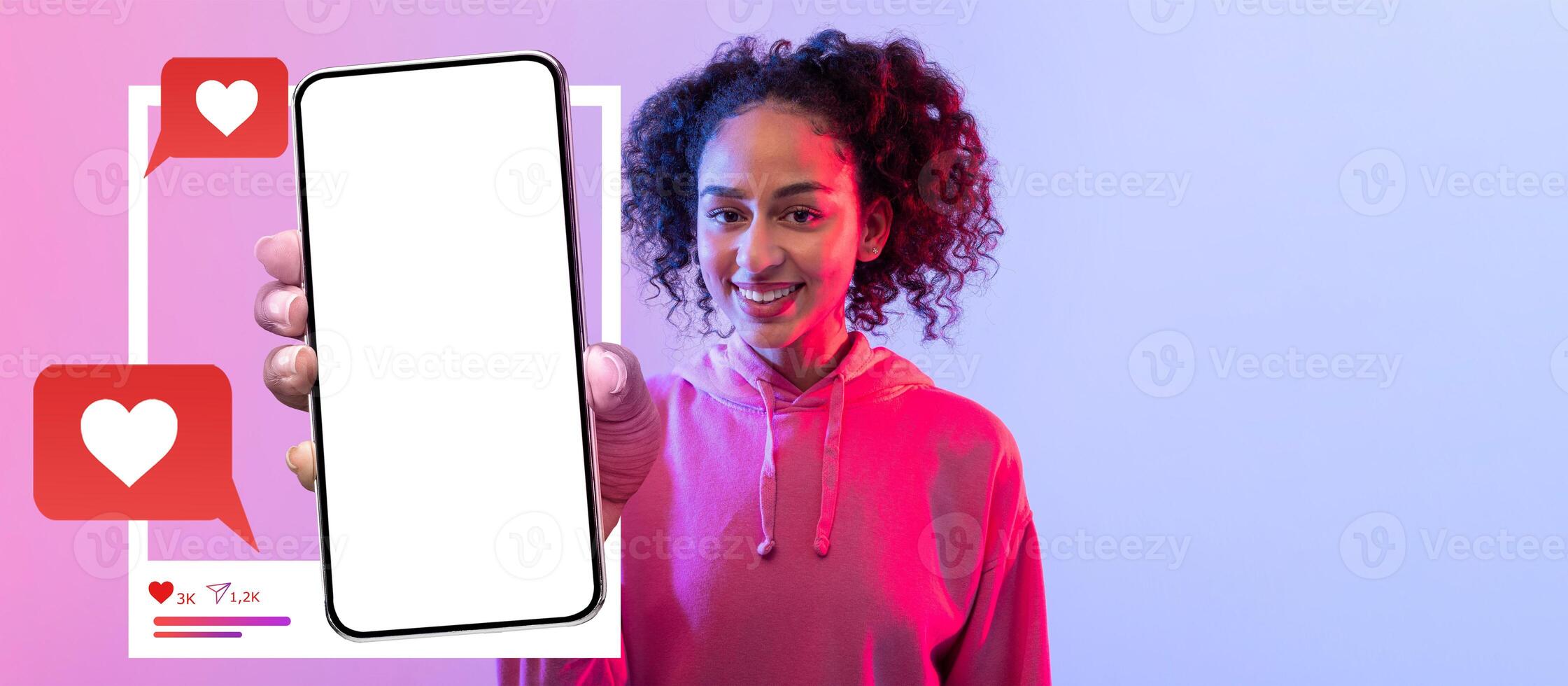 A lively influencer holds a smartphone with a blank screen, ready for social media content creation. The colorful background enhances the excitement of connecting online with followers. photo