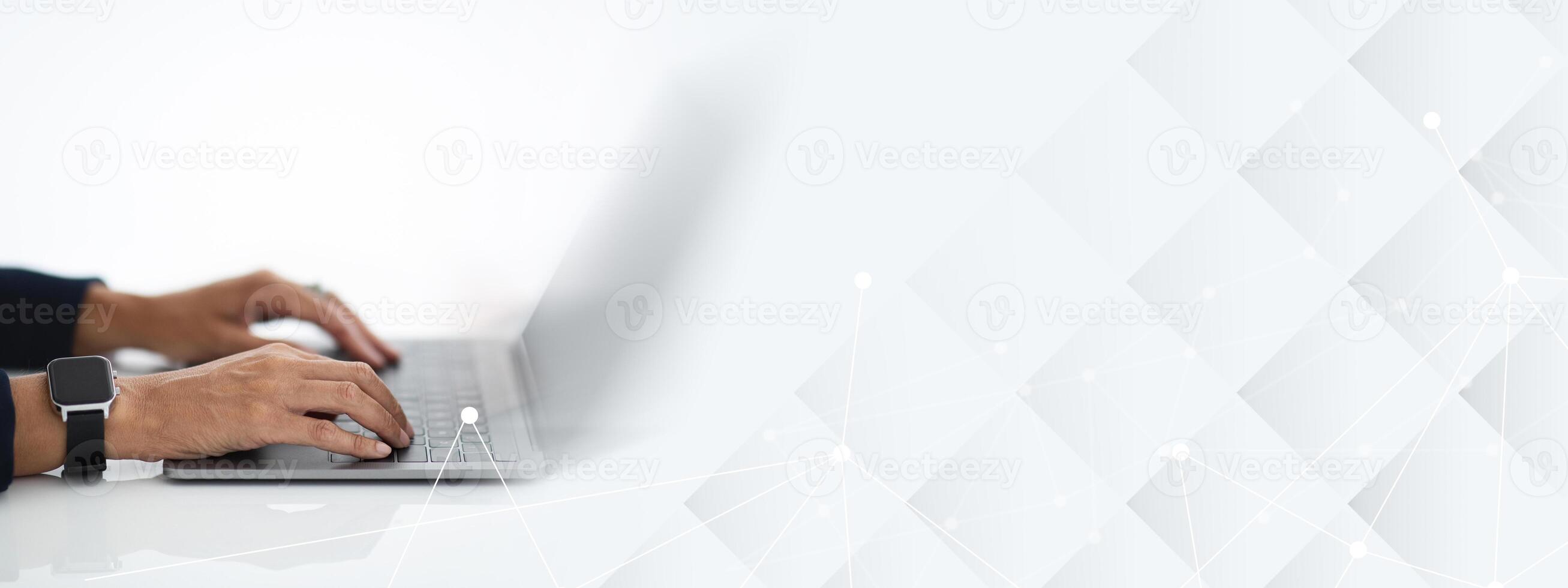 Unrecognizable mature woman with smart watch on her hand wearing formal outfit sitting at workdesk at office, typing on computer laptop keyboard, white background, blank screen, cropped photo