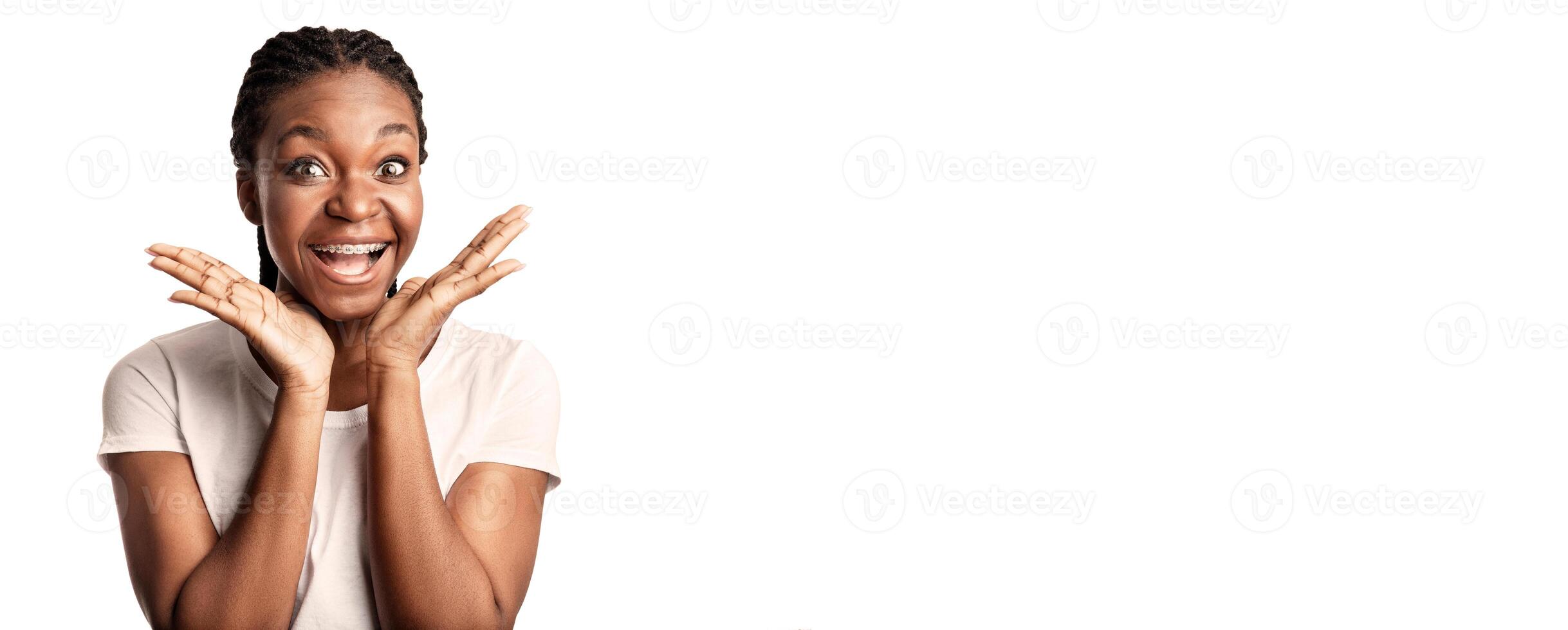 A cheerful woman indoors displays her joy with an animated smile and raised hands, conveying happiness and enthusiasm. Her positive energy is infectious and inviting. photo