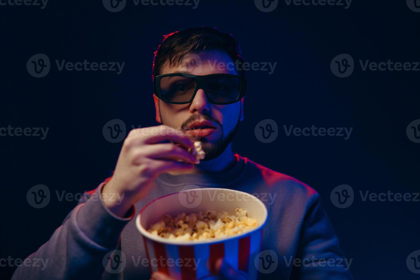 A guy in 3 glasses is watching a movie. Waiting for the premiere. photo