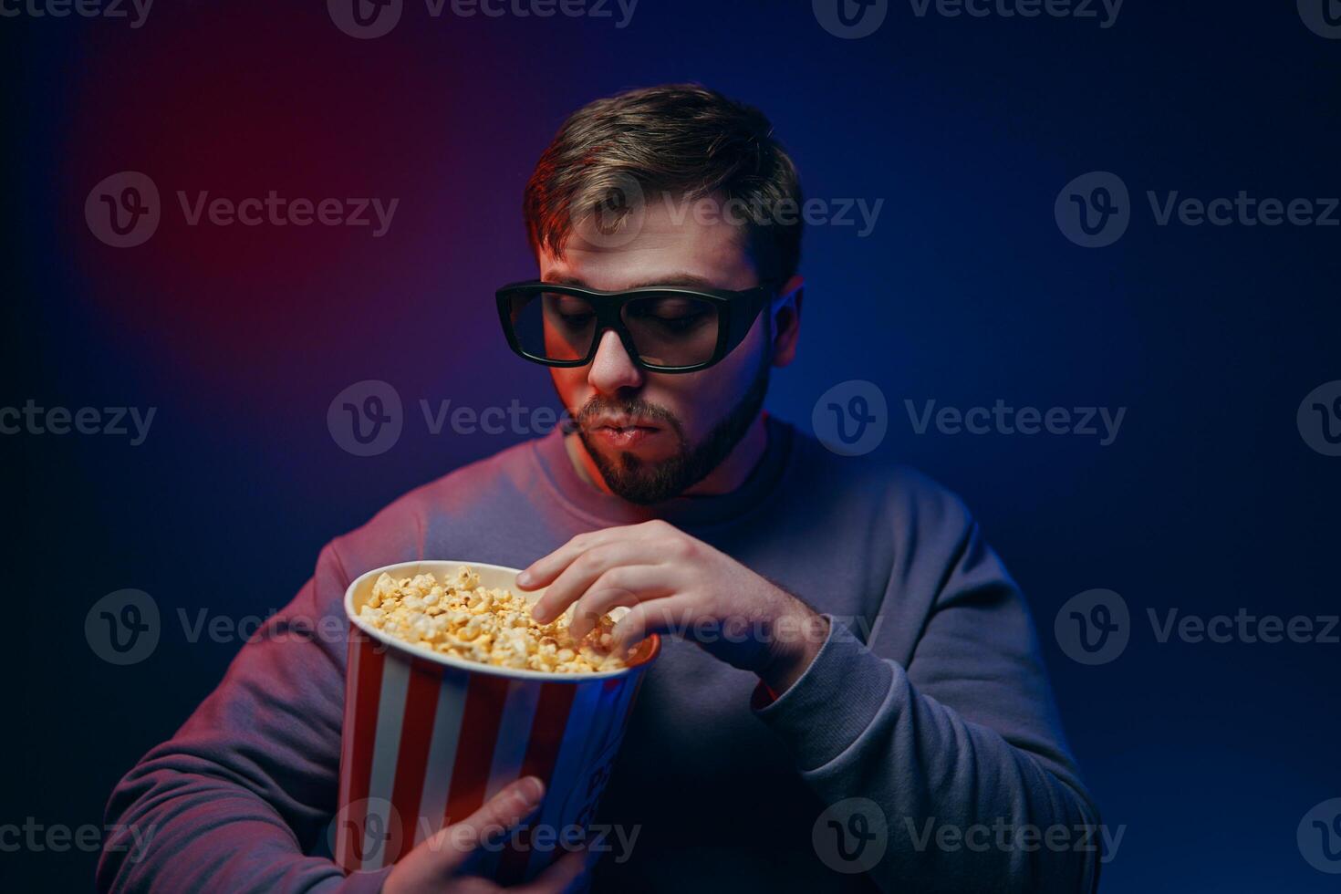 A guy in 3 glasses is watching a movie. Waiting for the premiere. photo