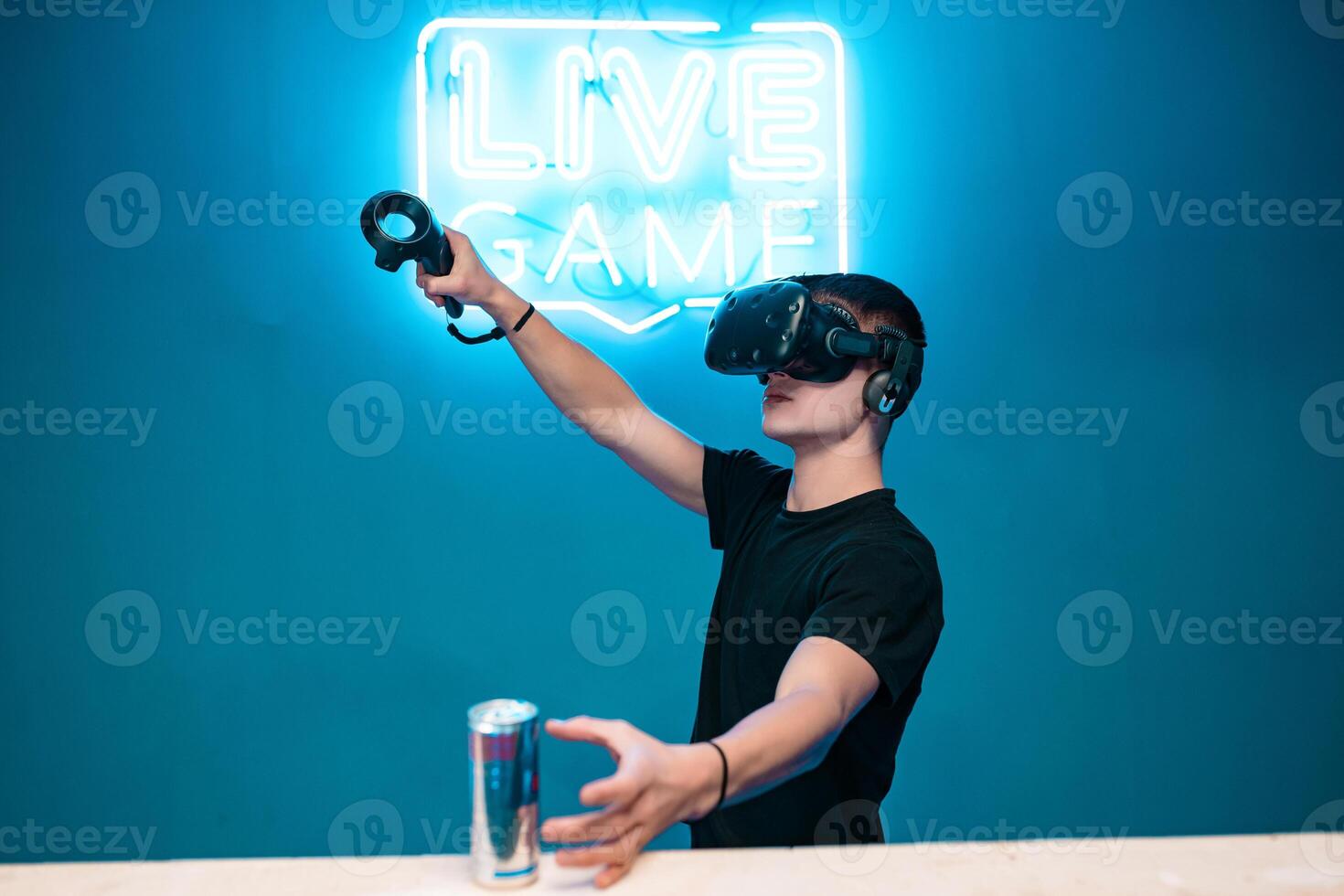 A young man drinks energy while playing photo