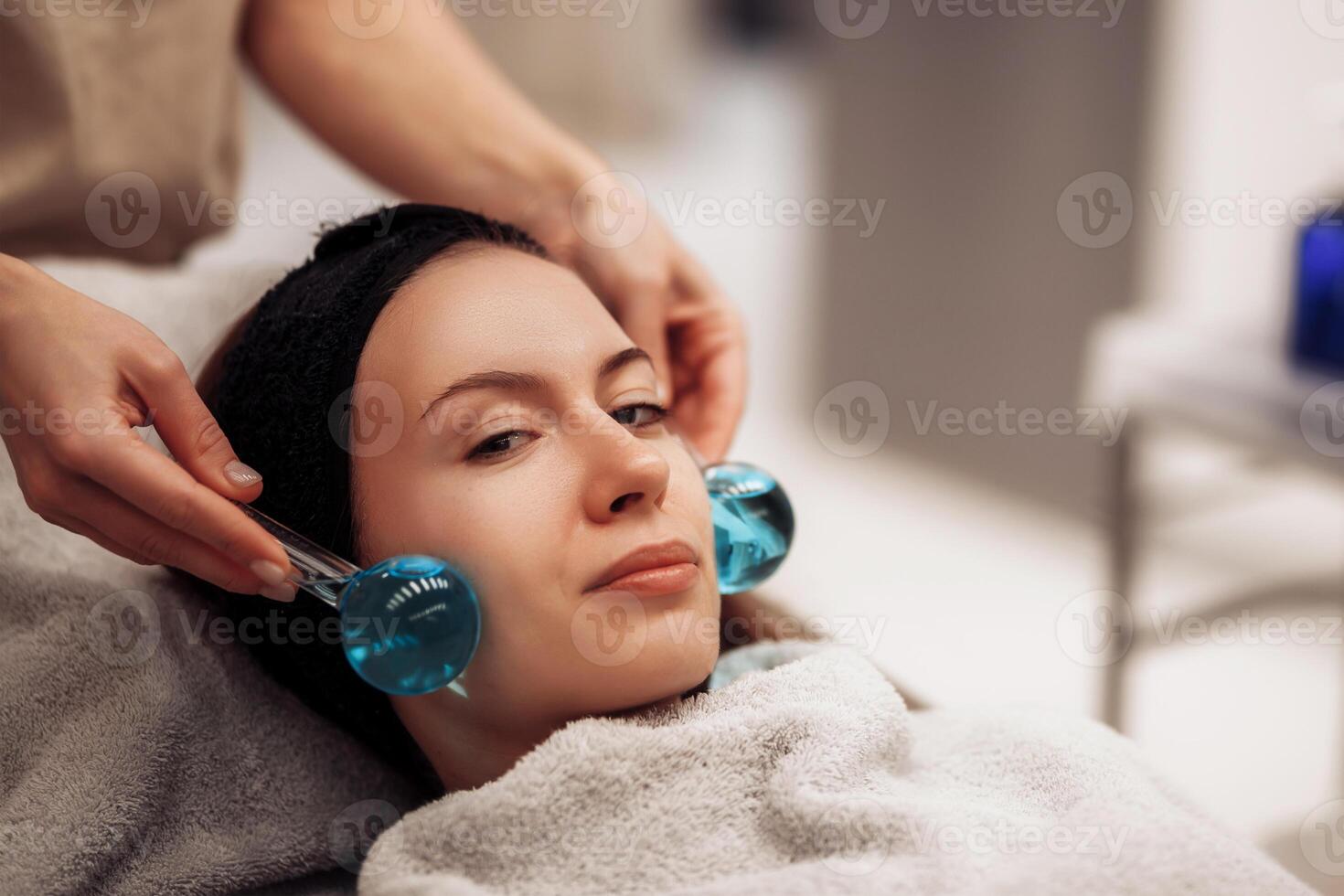 The woman is massaged face and body. photo