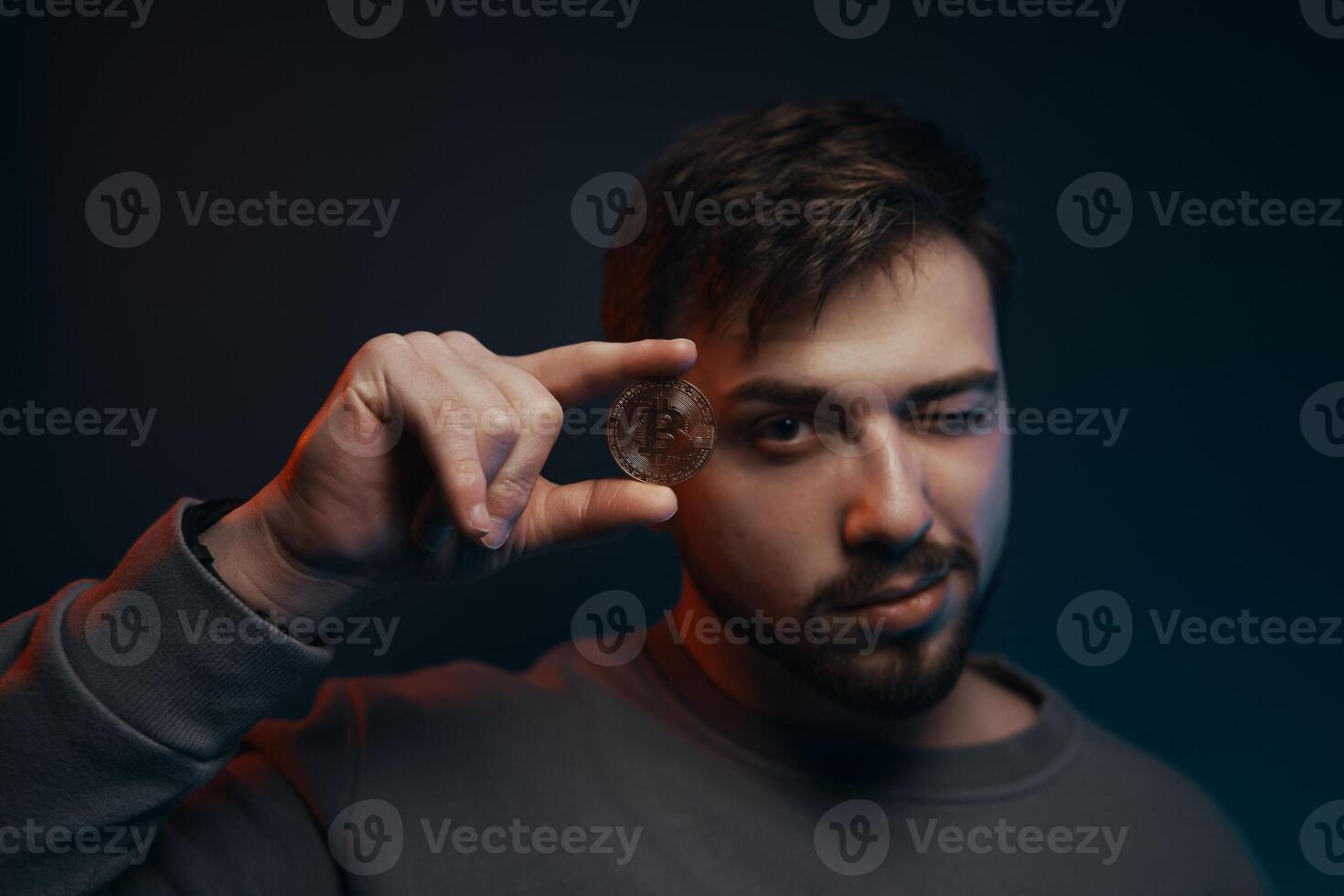 Man holding bitcoin. Cryptocurrency in hand. photo
