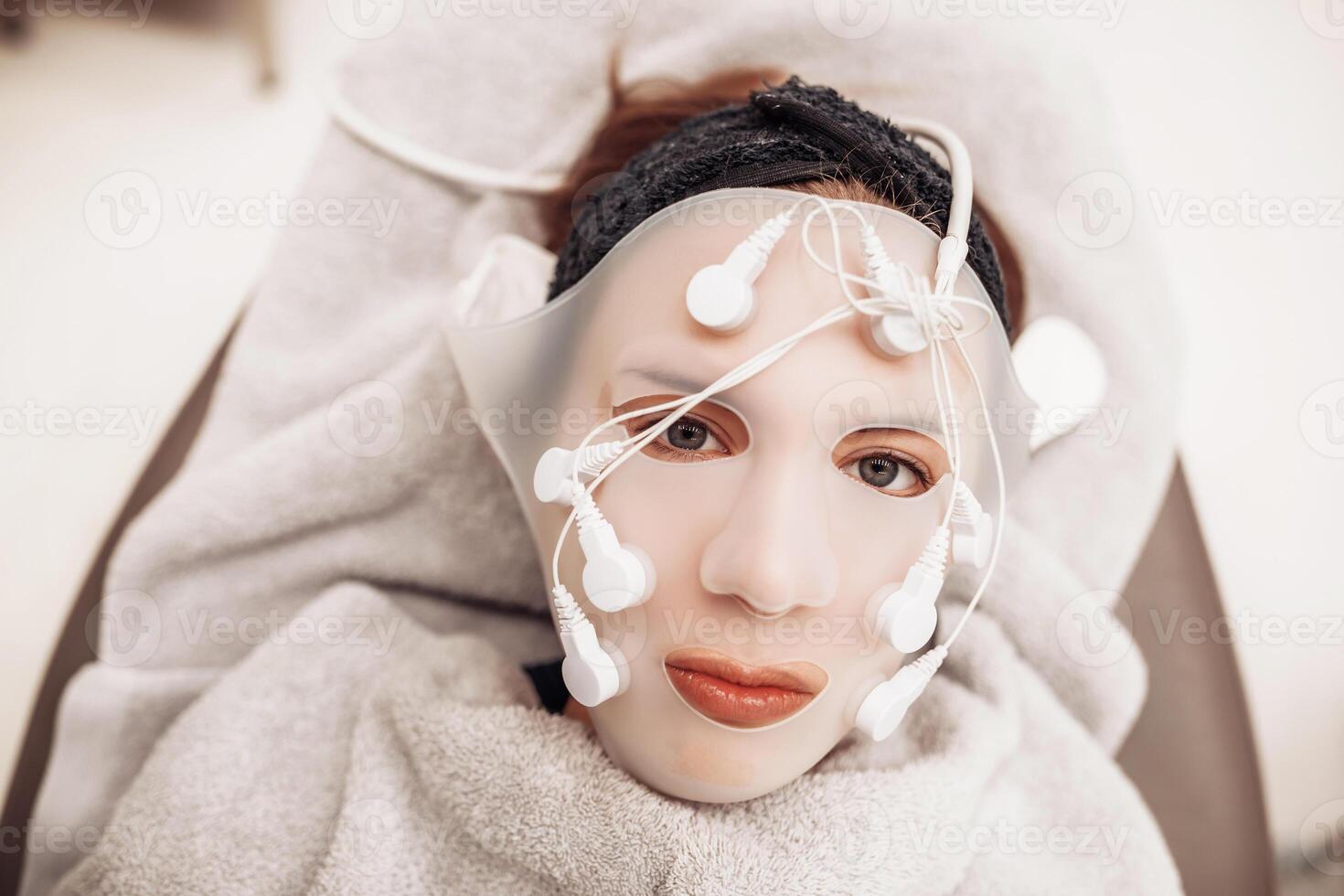 Woman receiving facial massage in beauty salon. photo