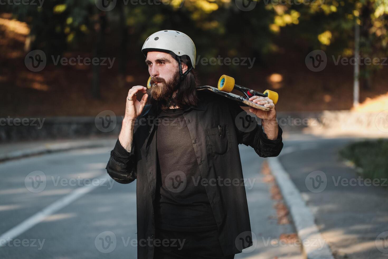 The guy with the board smokes a cigarette. Lifestyle style. photo