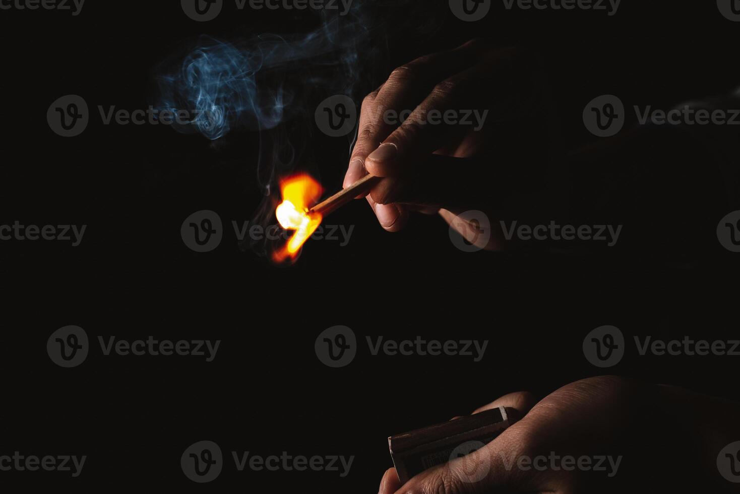 Burning match in the man's hand. Dangerous game with fire. photo