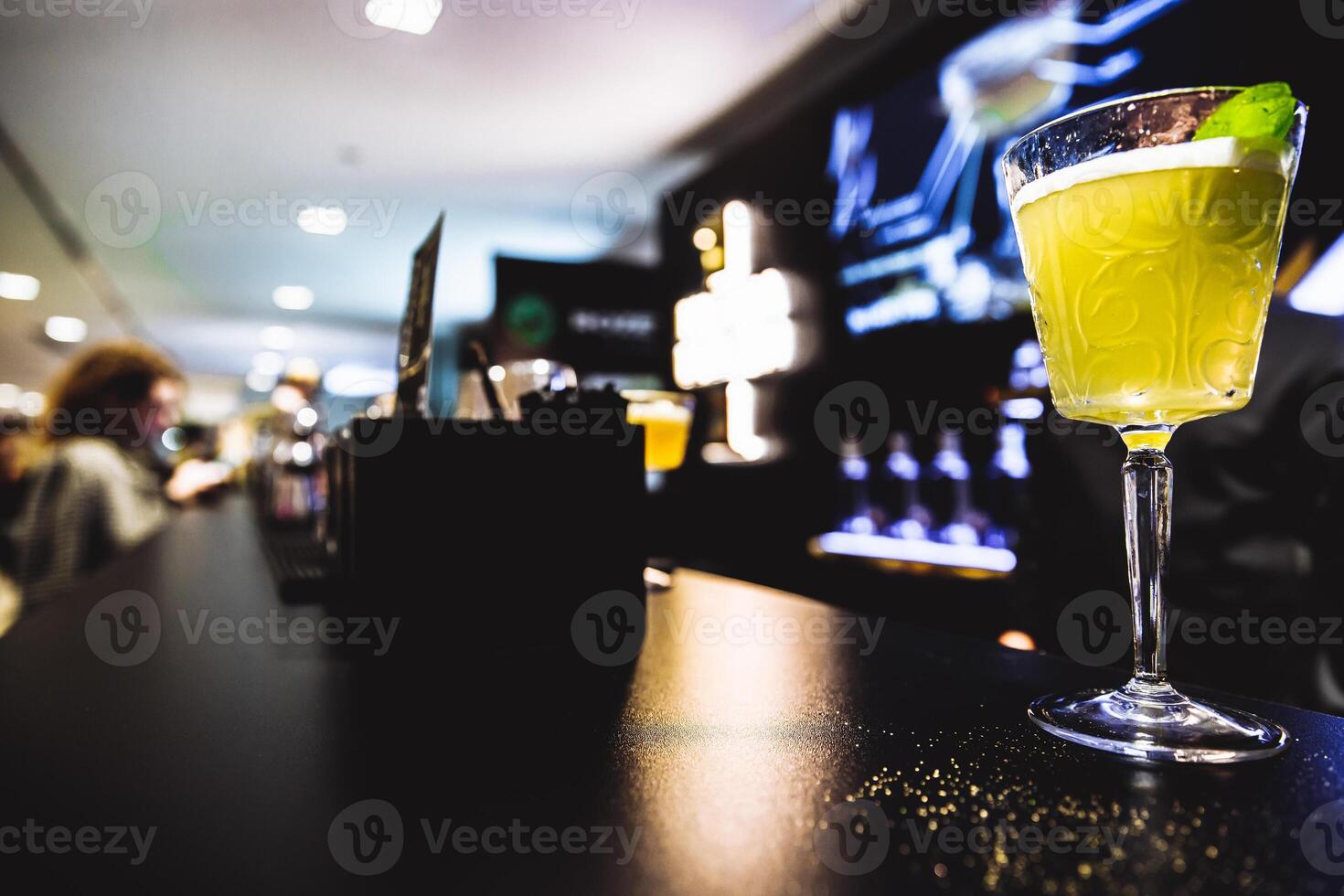 Yellow cocktail on the bar. photo