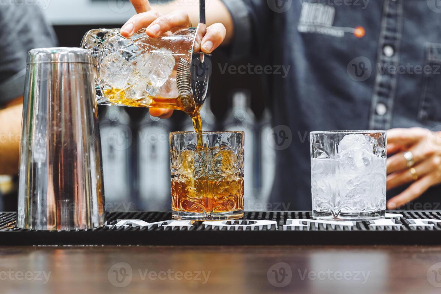 Brown alcoholic cocktail with ice in restaurant photo