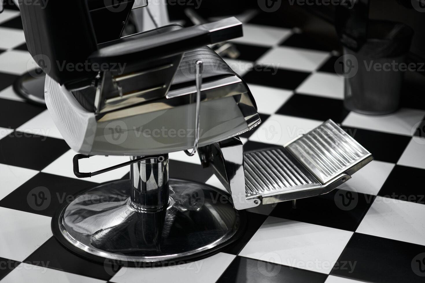 Modern barber chair with footrest in a stylish black and white salon photo