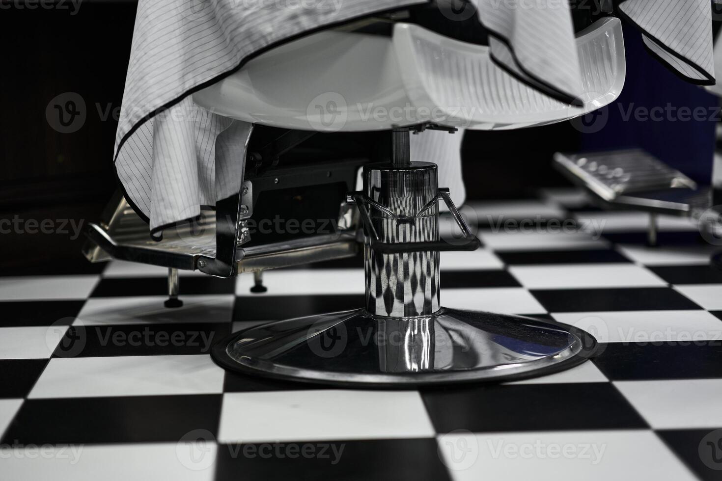Stylish barber chair in modern salon with black and white checkered floor photo