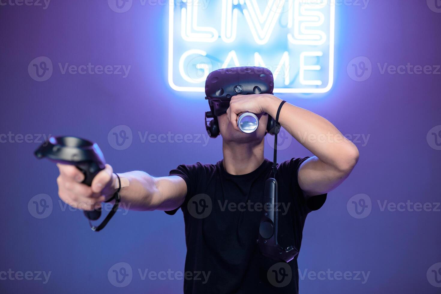 A young man drinks energy while playing photo