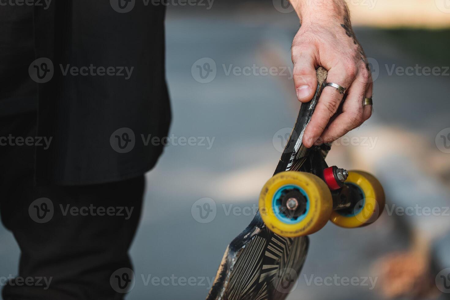 Longboard close-up. Skate in the hands of a guy. photo
