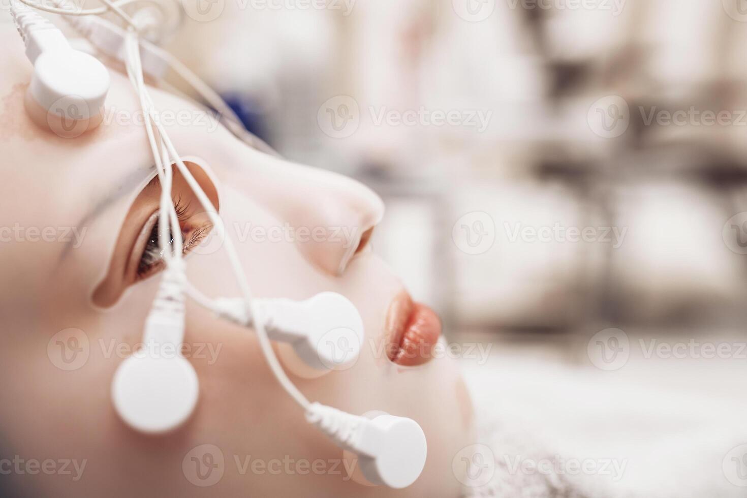 Woman receiving facial massage in beauty salon. photo