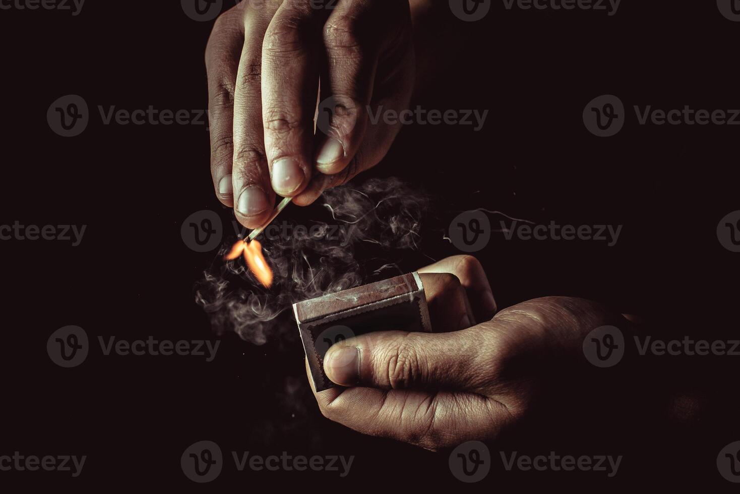 Burning match in the man's hand. Dangerous game with fire. photo
