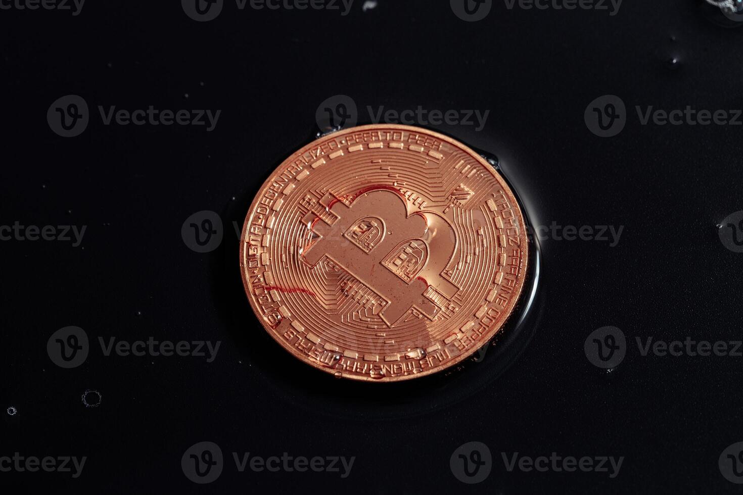 Bitcoin on black background. Bitcoin laundering with water. photo