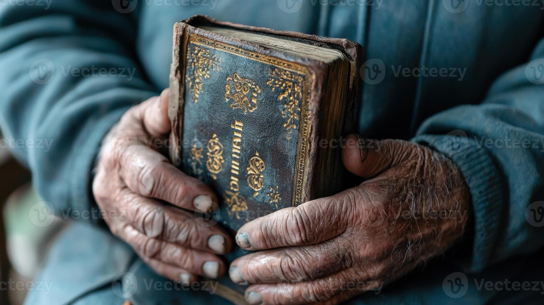 Old hands holding a bible photo