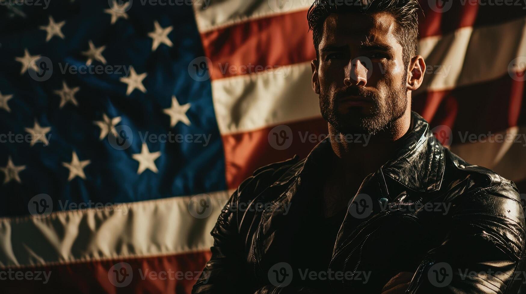A man in leather jacket standing in front of an american flag photo