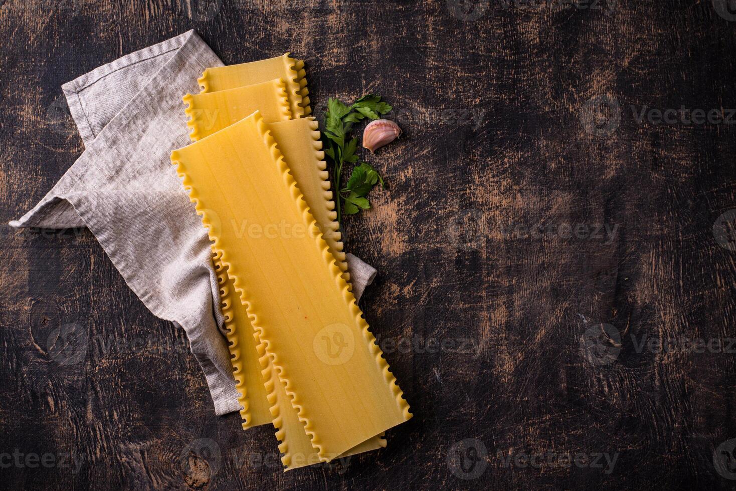 Uncooked lasagna pasta with cooking ingredient photo