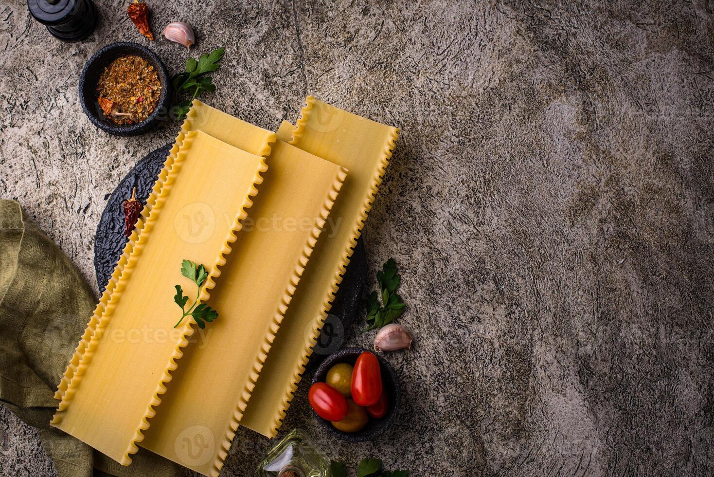 Uncooked lasagna pasta with cooking ingredient photo