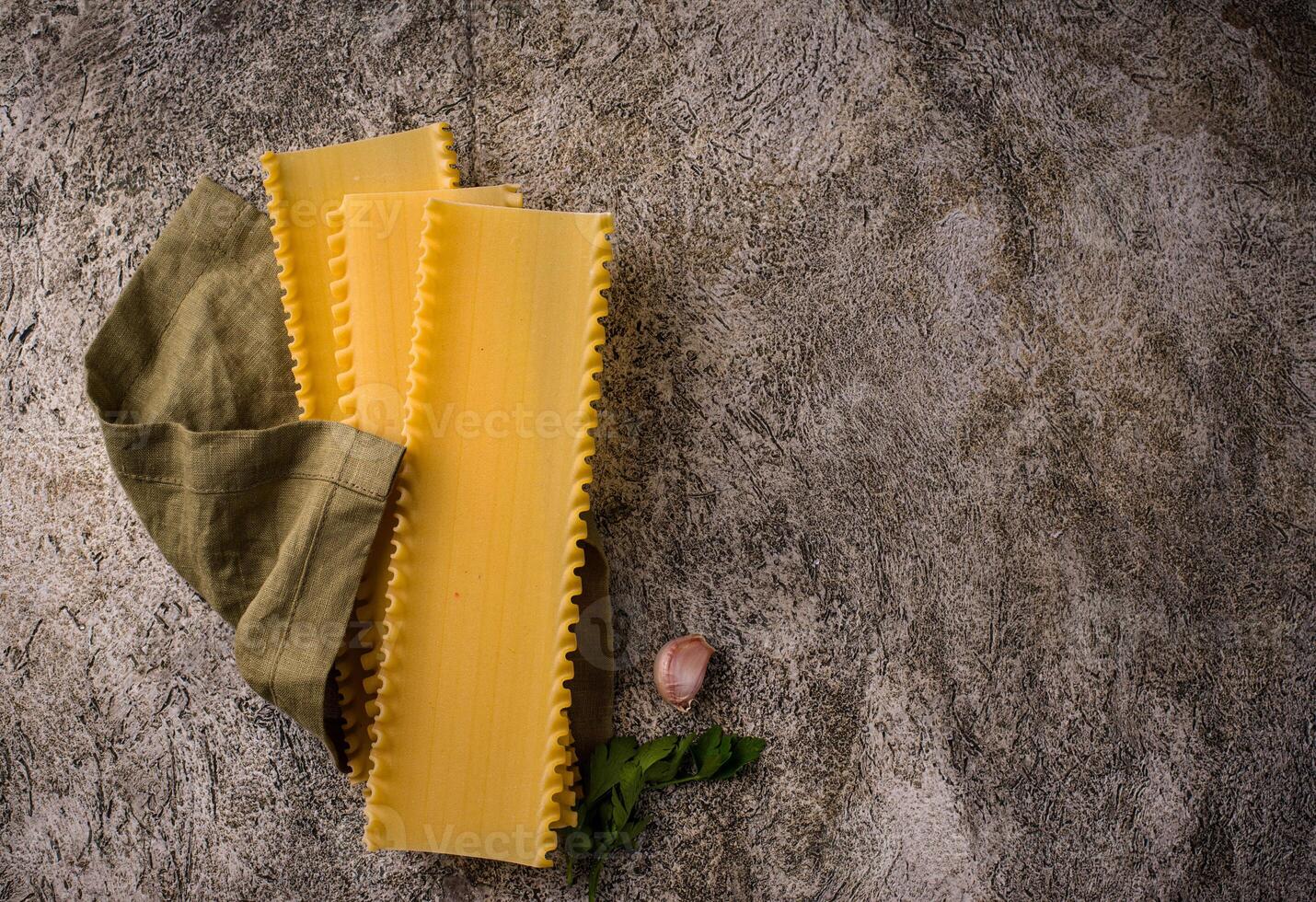 Uncooked lasagna pasta with cooking ingredient photo