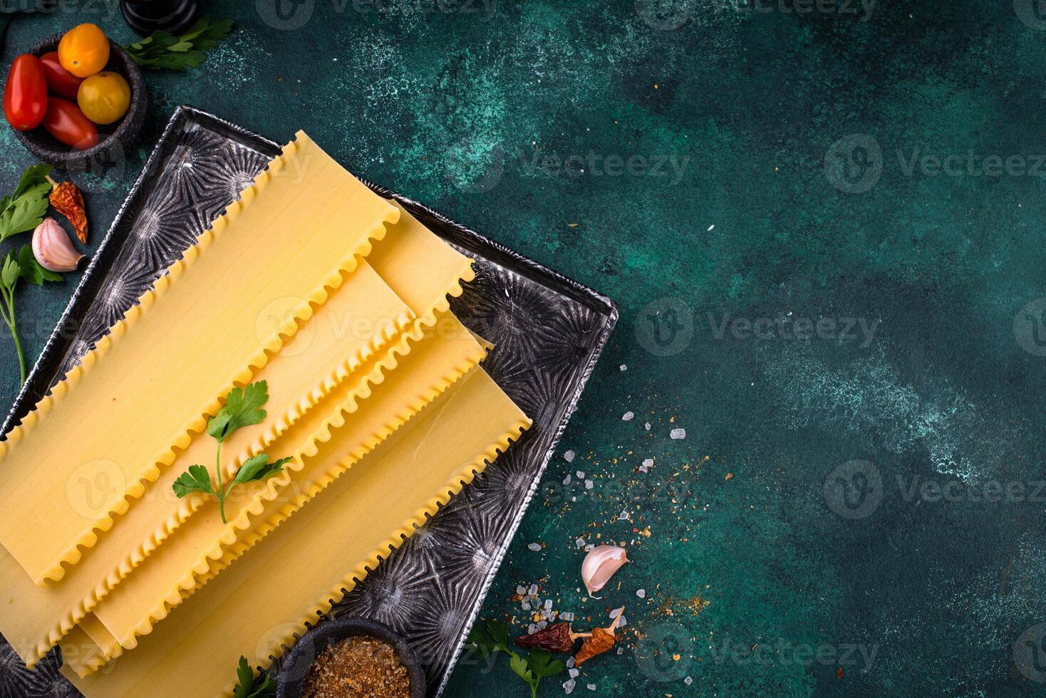 Uncooked lasagna pasta with cooking ingredient photo
