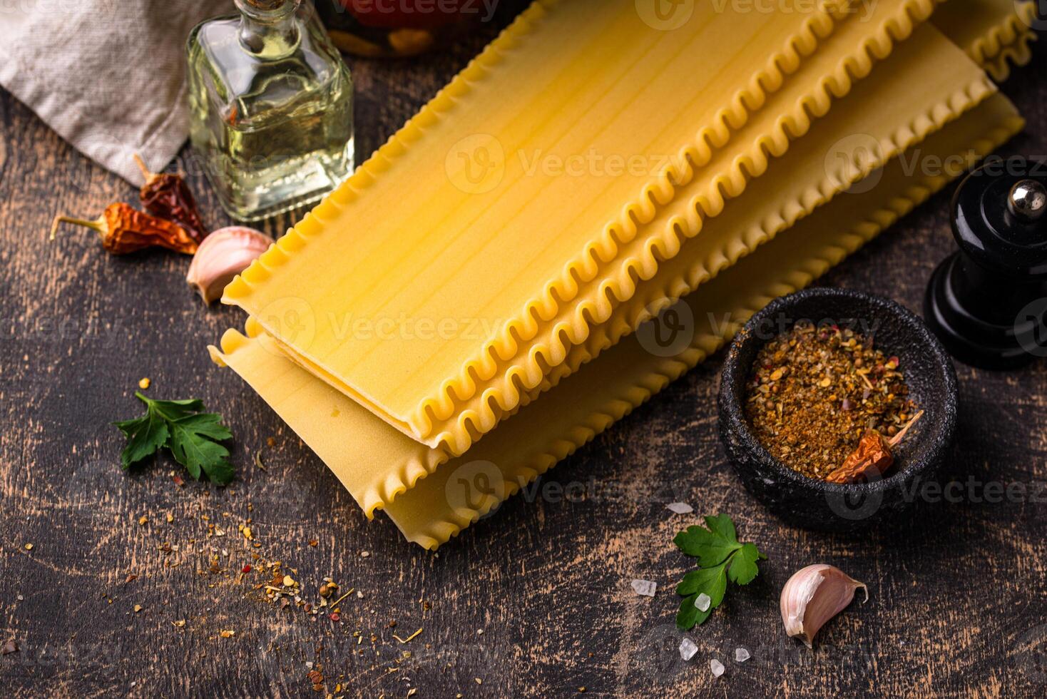 Uncooked lasagna pasta with cooking ingredient photo