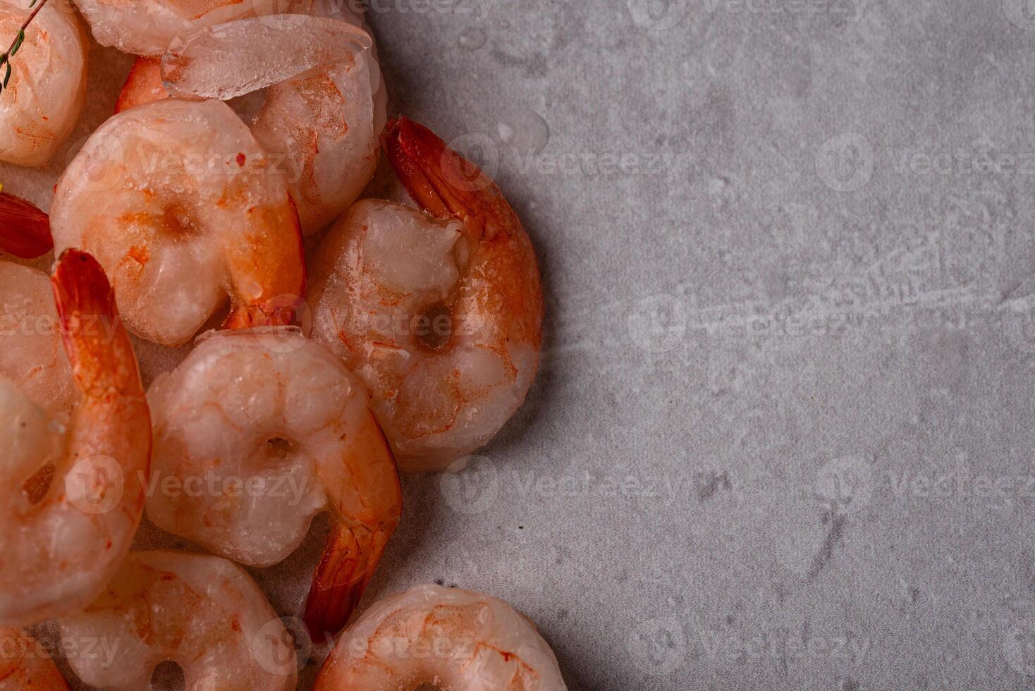 Frozen uncooked prawns or shrimps with lemon photo