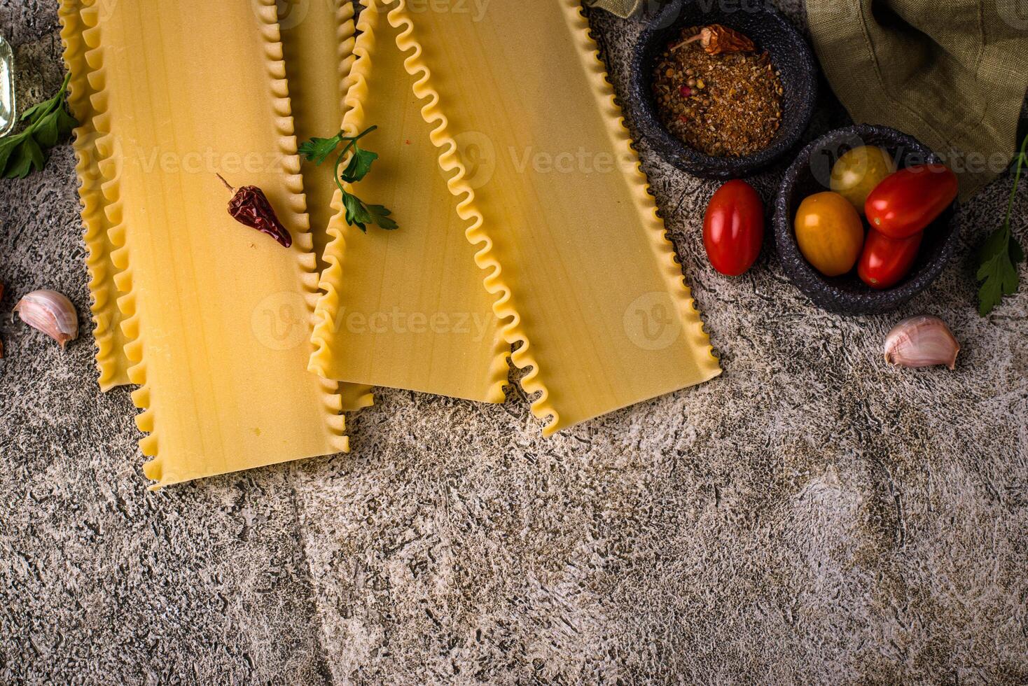 Uncooked lasagna pasta with cooking ingredient photo