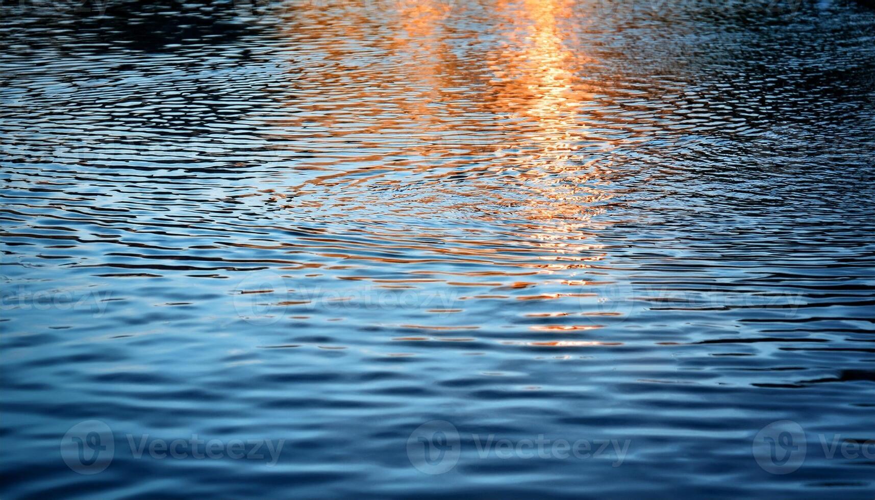 Reflections of Sunlight Shimmer on the Surface of Tranquil Water During Golden Hour by the Lakeside photo