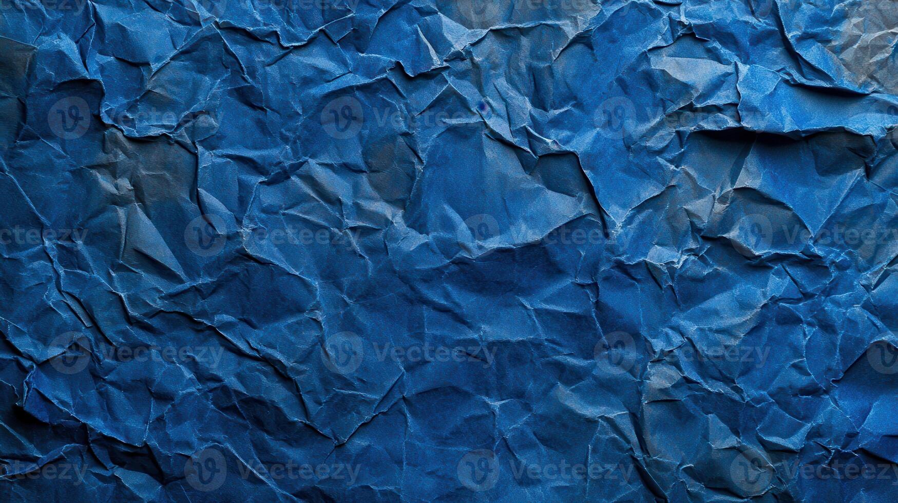Crumpled blue paper background with a blue color photo