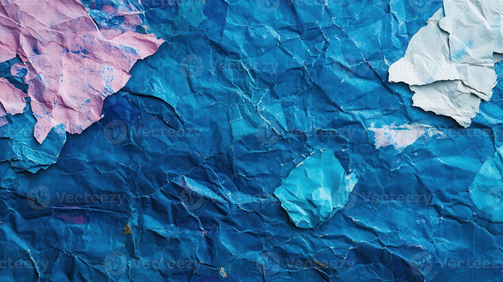 A blue crumpled paper wall with pink and blue paint photo