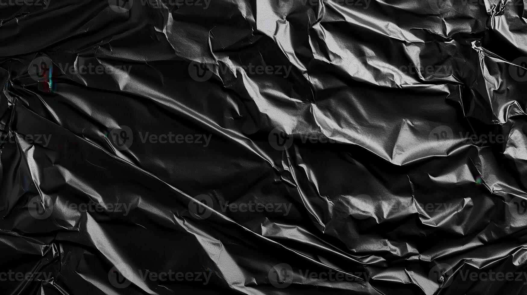 Crumpled black plastic background photo