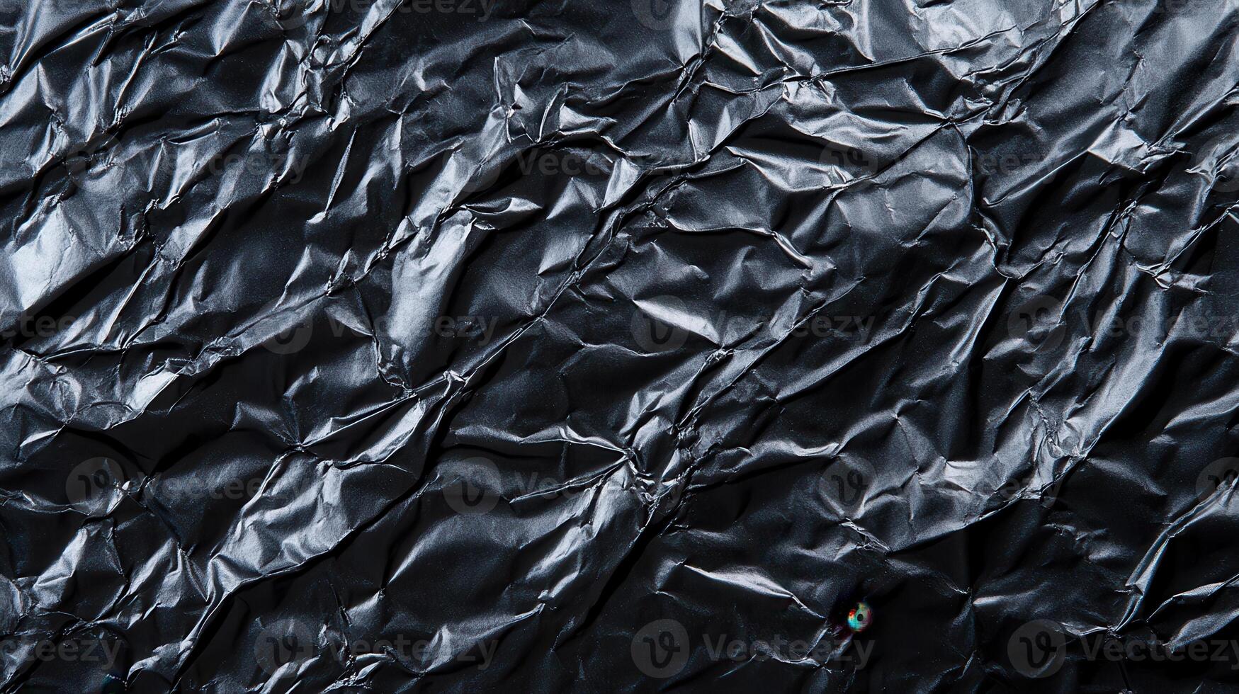 A black background with crumpled paper photo