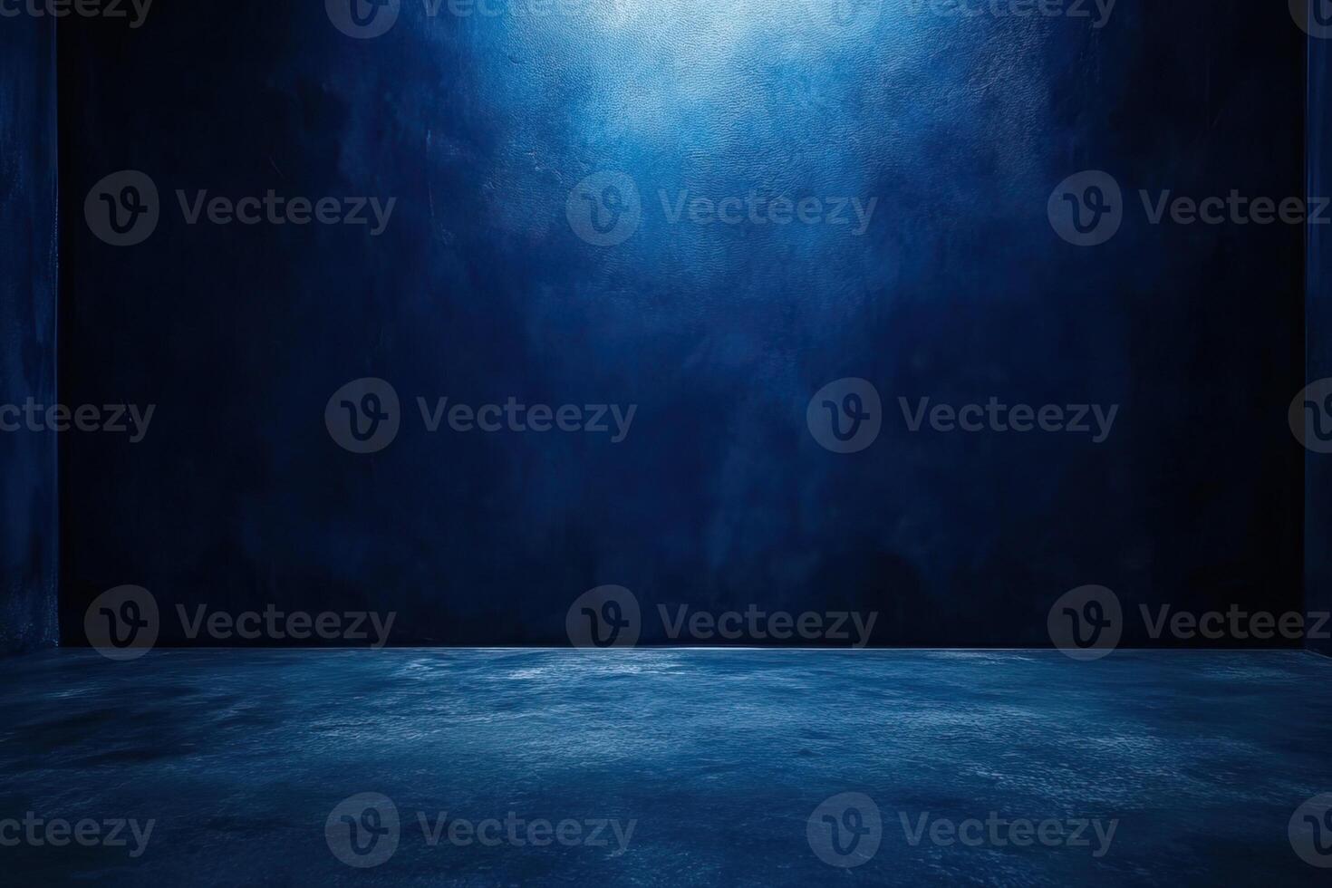 Dark blue studio backdrop, empty room, concrete floor, spotlight photo