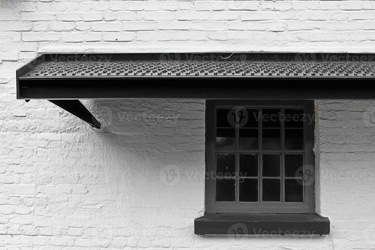A close-up of a window and overhanging roof. photo