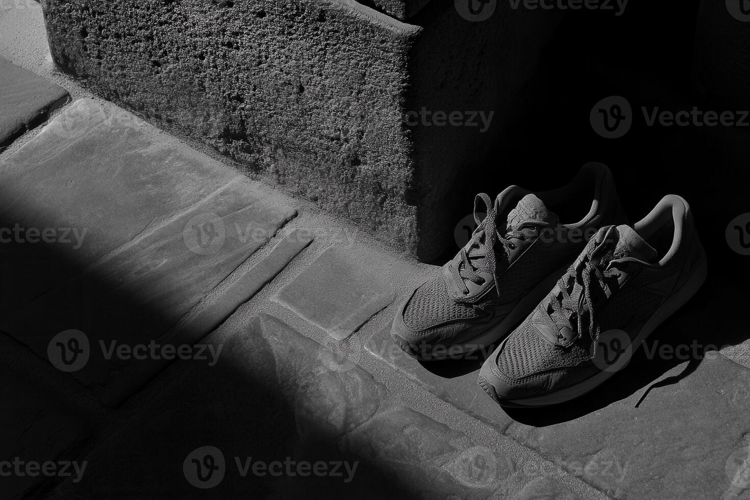 A pair of sneakers resting on a stone surface. photo