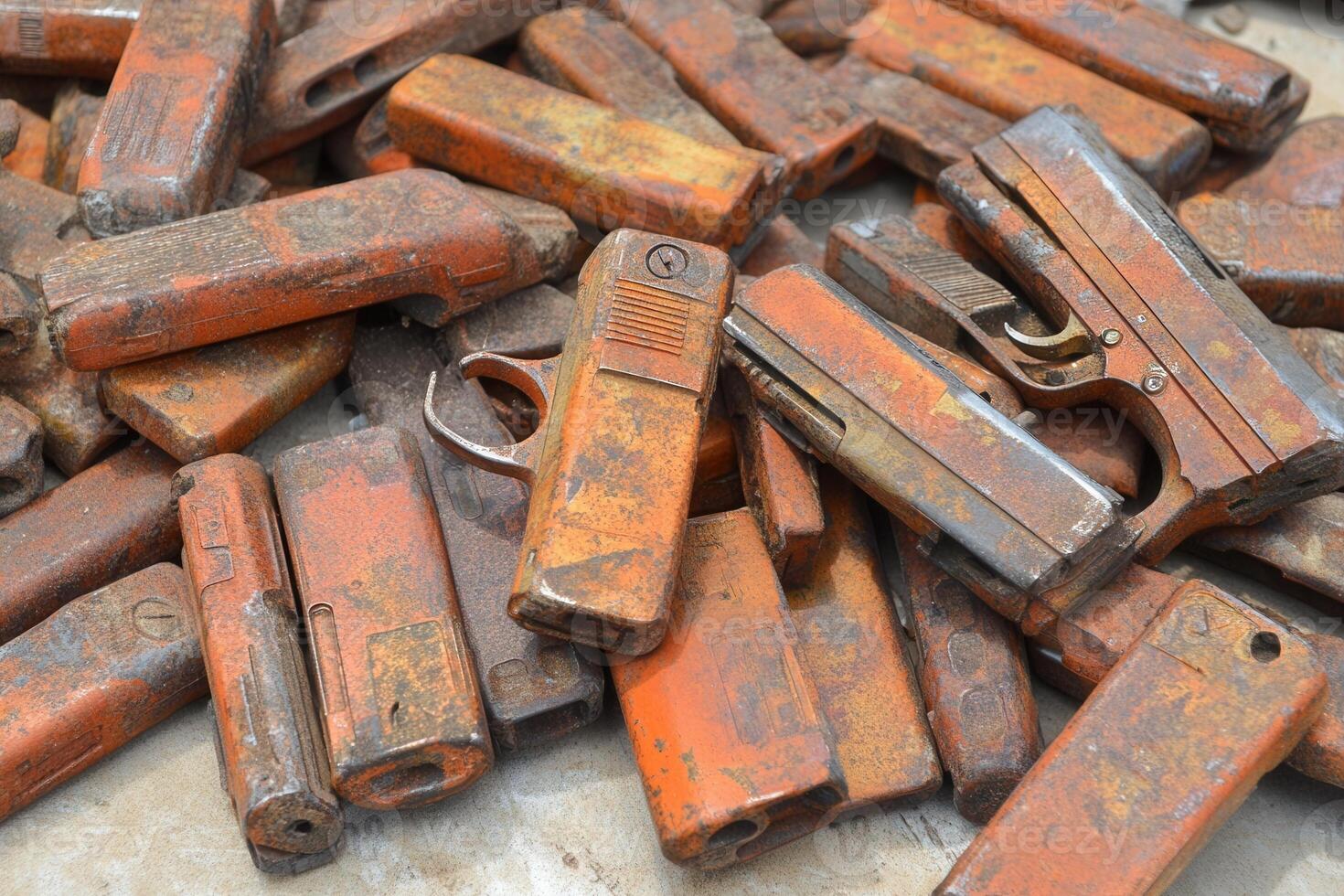 A pile of rusty, old firearms stacked together. photo