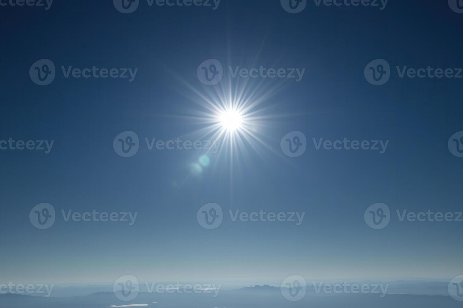 Bright sun shining in a clear blue sky. photo