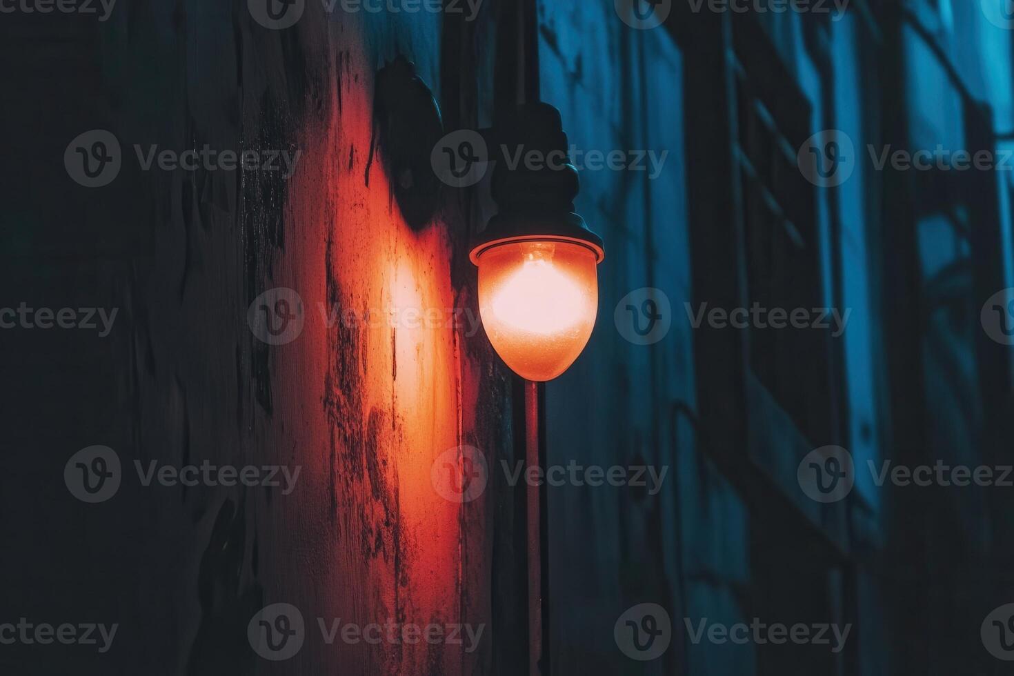 A warm light fixture illuminating a textured wall. photo