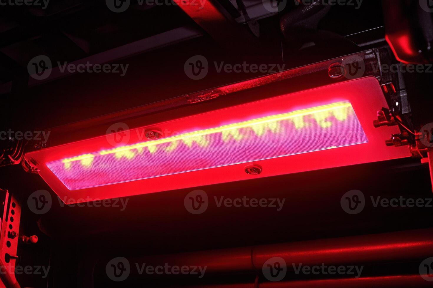 Bright red light panel under machinery. photo
