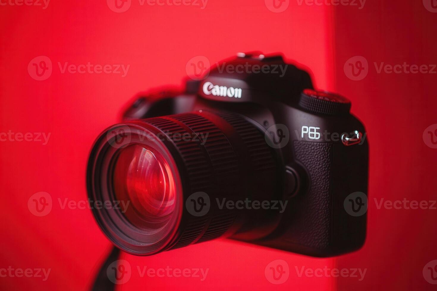 Camera with a red backdrop, highlighting photography gear. photo