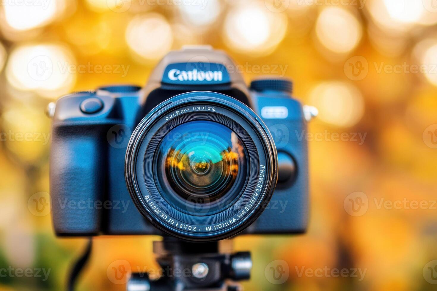 Camera with lens against a blurred autumn background. photo