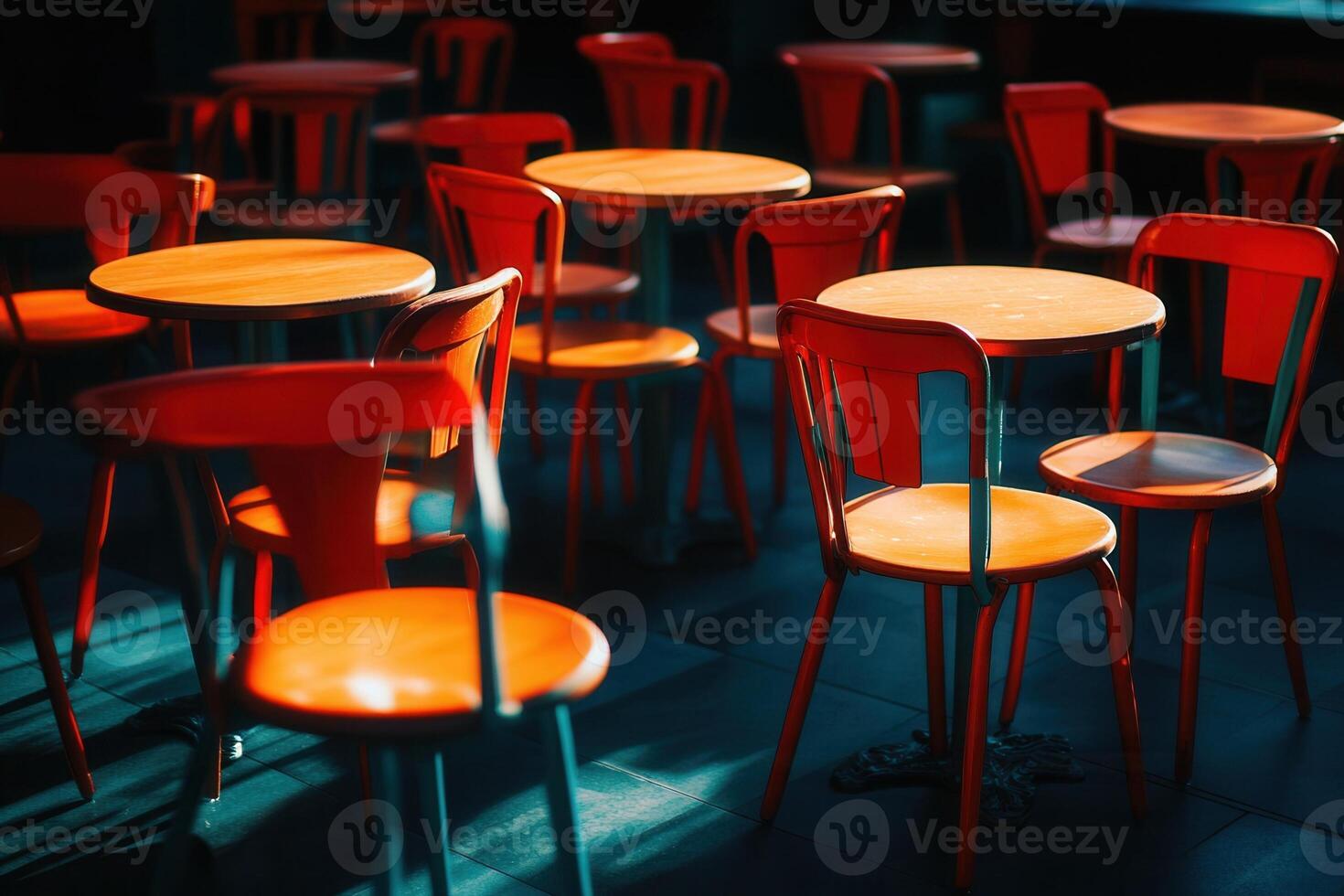 Brightly colored chairs and tables in a dim setting. photo