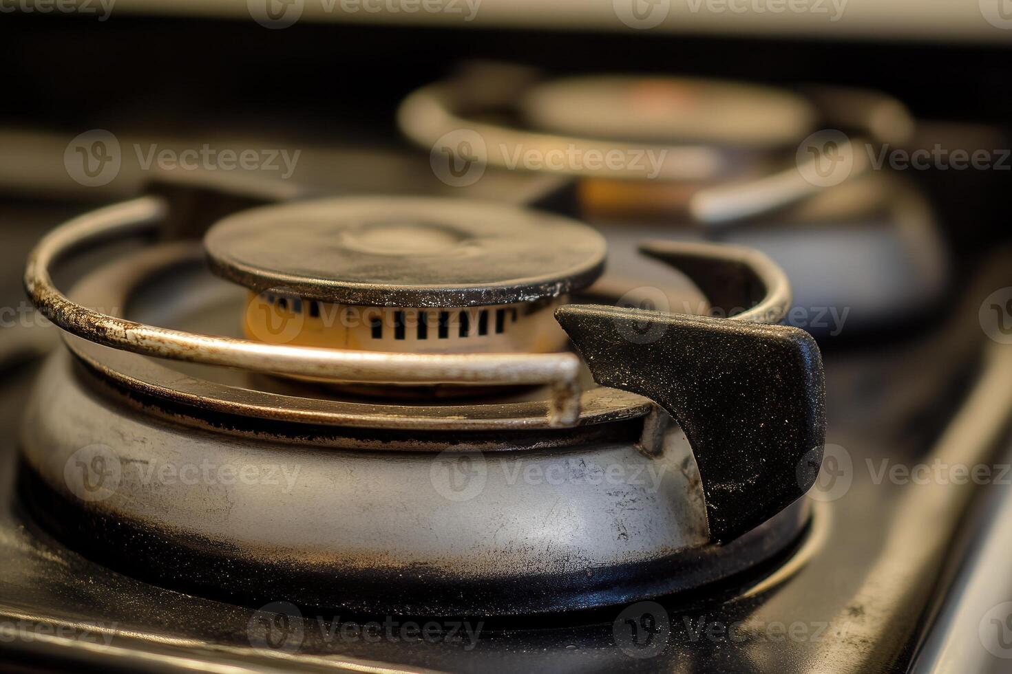 Close-up of a gas stove burner, showing wear and use. photo