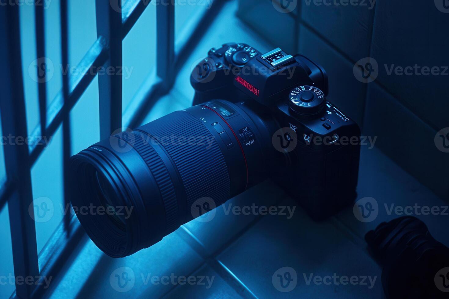 Camera resting near a window with soft blue lighting. photo