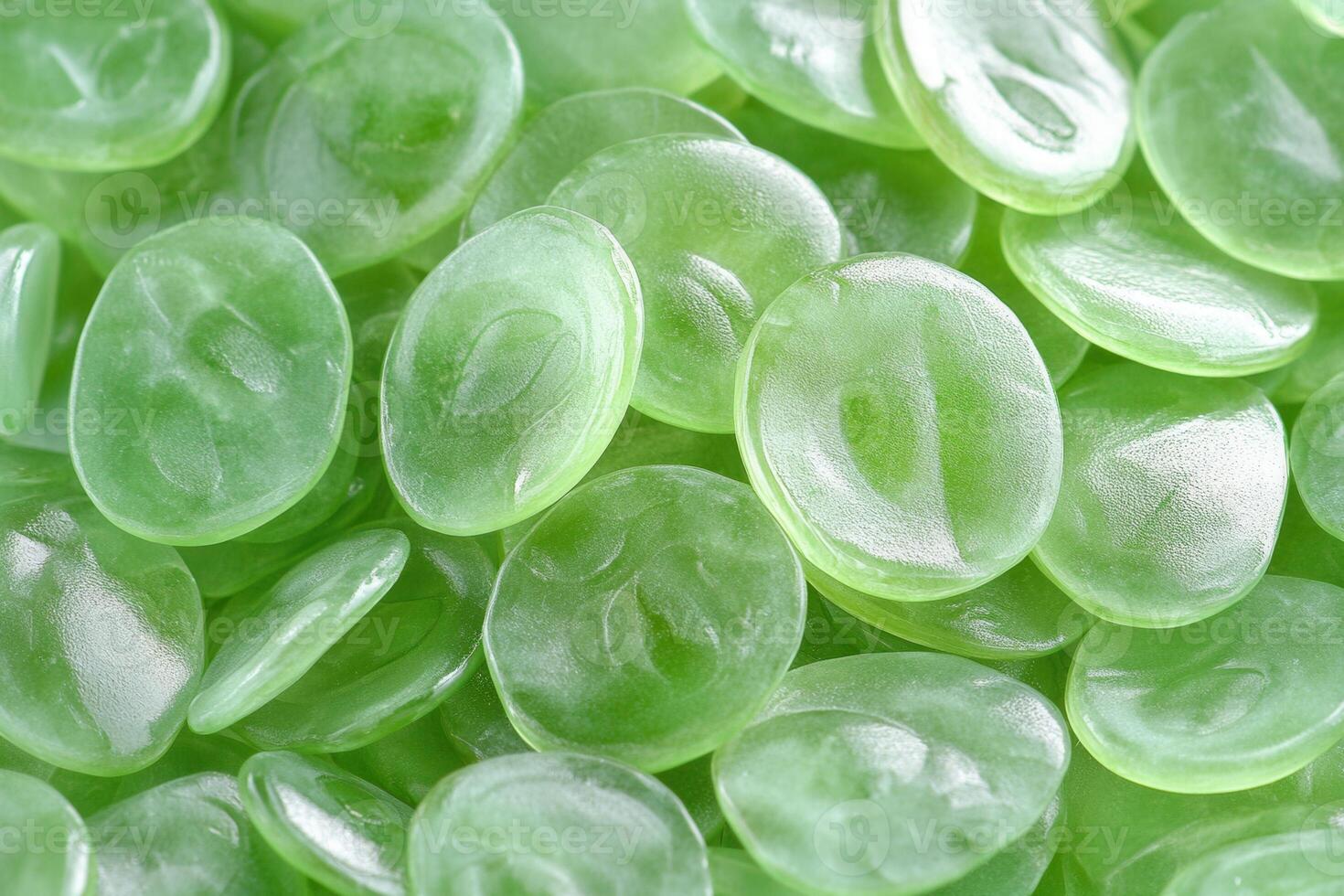 Close-up of glossy green oval-shaped objects. photo
